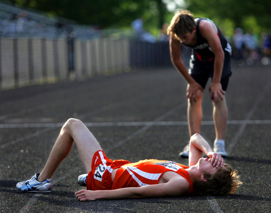 Second Place, Photographer of the Year Large Market - Gus Chan / The Plain DealerEastlake North's Cody Lancaster lays exhausted after finishing the boys 1600 meter run in the  Division I District meet .