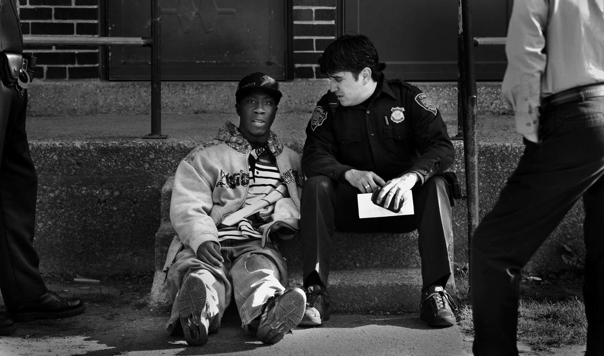 Second Place, Photographer of the Year Large Market - Gus Chan / The Plain DealerCuyahoga Metro Housing Authority police officer Clint Ovalle talks to a mentally handicapped adult at CMHA's Outhwaited Estates.  Ovalle was trying to convince him that he was running with the wrong crowd. 