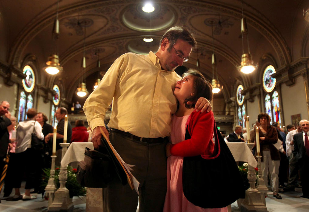 Second Place, Photographer of the Year Large Market - Gus Chan / The Plain DealerMark Holan (left) of Cleveland, comforts his daughter, Annie, as the two were standing on the altar after the final mass at St. Procop Church.  The church closed it's doors for the final time after the morning service. 