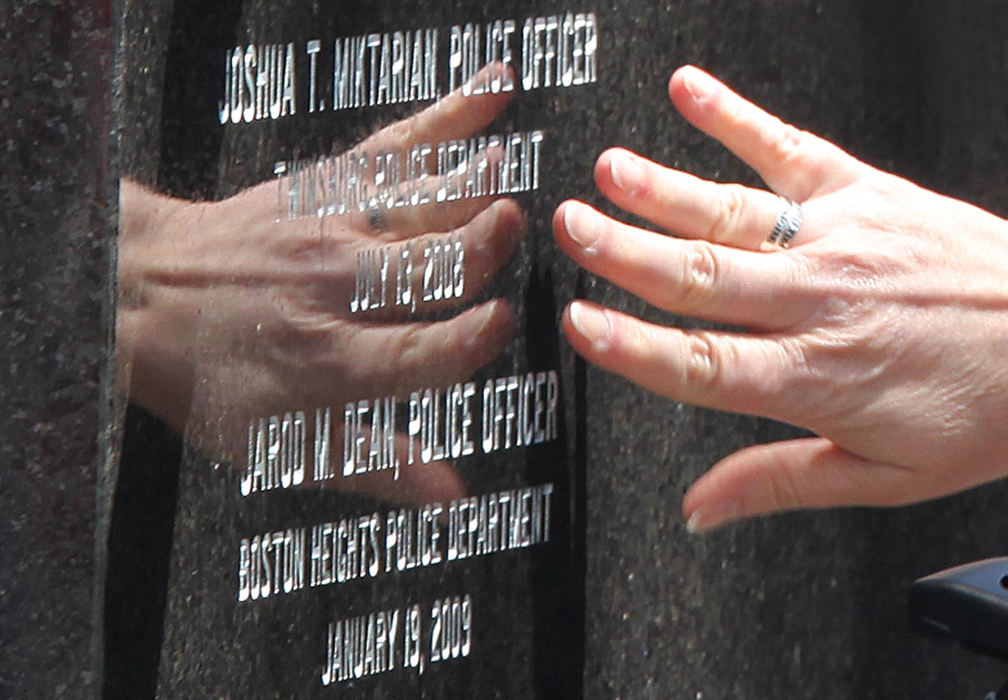 Third Place, Photographer of the Year Large Market - John Kuntz / The Plain DealerThe hand of a friend of slain Twinsburg police officer Joshua Miktarian reaches out to touch the engraved letters while she said goodbye May 15, 2009 after the 24th Annual Greater Cleveland Peace Officers Memorial Service honoring officer Joshua Miktarian and Boston Heights police officer Jarod Dean. 