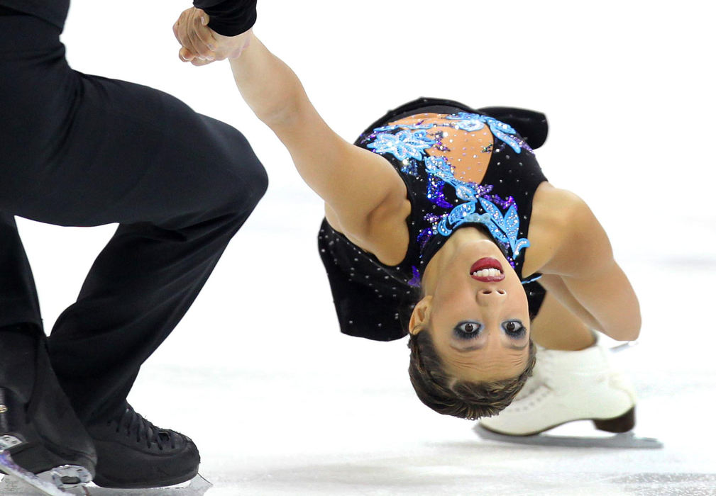 Third Place, Photographer of the Year Large Market - John Kuntz / The Plain DealerIn the firm grip of partner Rockne Brubaker, Keauna McLaughlin spins inches above the ice during their short program at The Q. The defending national pairs champions are in second place. 