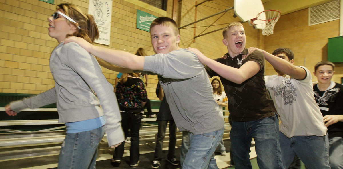 Third Place, Photographer of the Year Large Market - John Kuntz / The Plain DealerIan Stuart (second left) follows a fellow student as they line dance around the gym at St. Thomas More School during a Catholic Youth Organization teen dance February 13, 2009. 