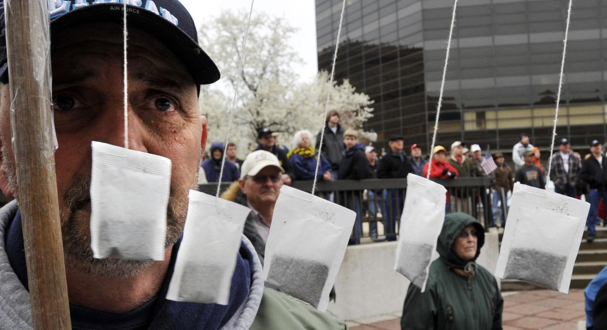 First Place, Photographer of the Year Small Market - Bill Lackey / Springfield News-SunTea bags hang from Jim Spanel's tax protest sign as he listens with hundreds of other protesters during the Tea Party on City Hall Plaza, April 15, 2009.