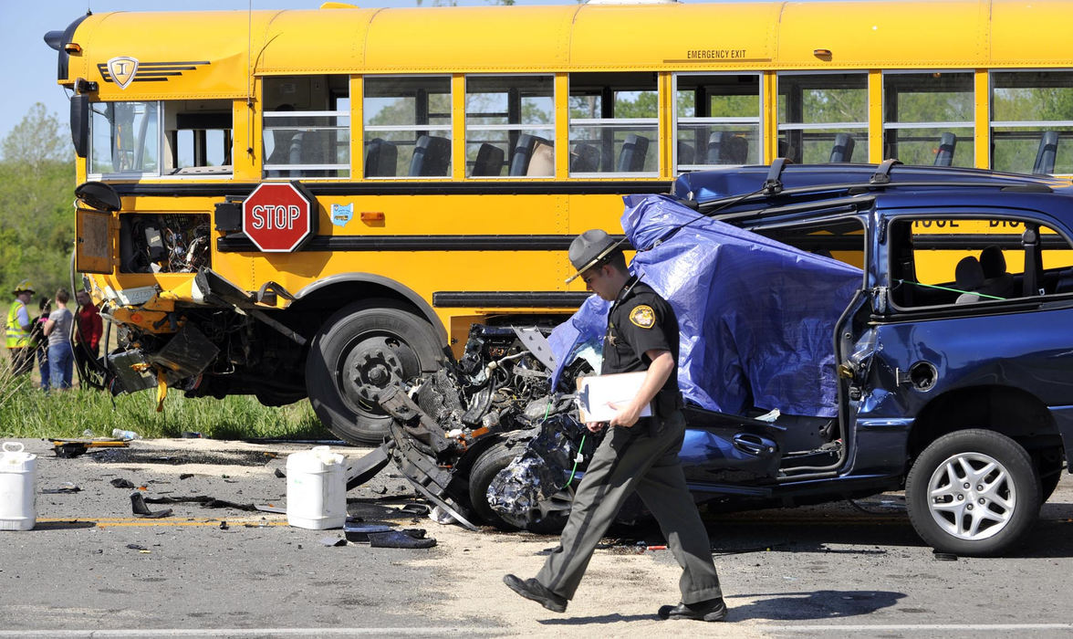 First Place, Photographer of the Year Small Market - Bill Lackey / Springfield News-SunSeveral Graham High School students were injured and the driver and passenger in a mini-van were killed when the two vehicles struck head-on along Ohio 36 in Champaign County May 21, 2009.  A Champaign County Sheriff's deputy walks past the accident as he investigates the scene.