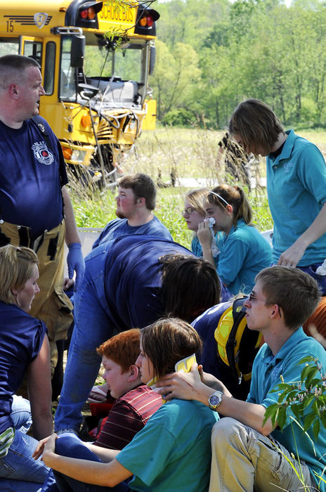 First Place, Photographer of the Year Small Market - Bill Lackey / Springfield News-SunChampaign County Vocational School students, riding on the bus back to Graham High School, help emergency personnel care for their injured classmates after their bus crashed head-on into a mini van on Ohio 36. 