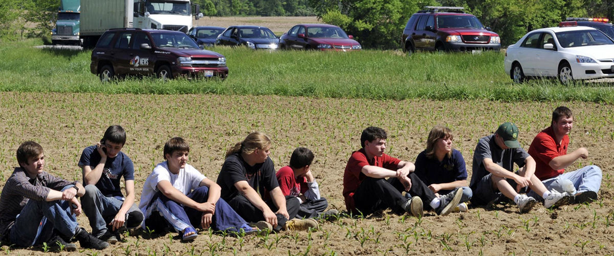 First Place, Photographer of the Year Small Market - Bill Lackey / Springfield News-SunUninjured students sit in a farm field along Ohio 36 as they wait for their parents to pick them up following the head-on collision with their bus.  