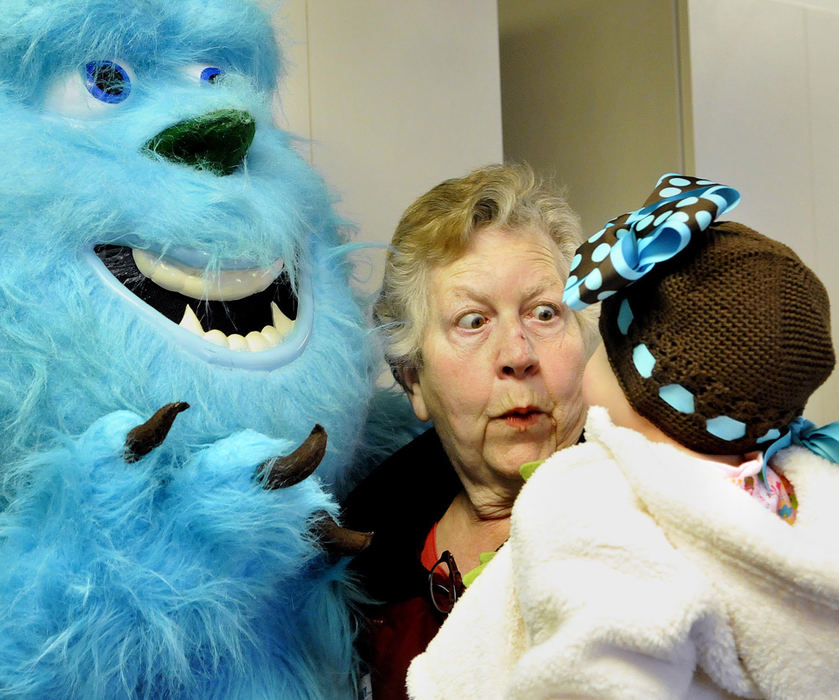 Second Place, Photographer of the Year Small Market - Marshall Gorby / Springfield News-SunJane Manemann reacts to the look Dec. 5, 2009 on 1-year-old Rilie Fisher's face after seeing Sulley from "Monsters Inc." at the New Carlisle fire department. Sulley had just attended the 24th annual holiday parade with Santa Claus. 