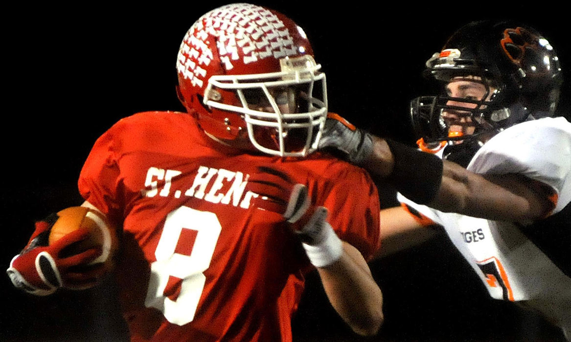 Second Place, Photographer of the Year Small Market - Marshall Gorby / Springfield News-SunNeil Schwieterman (8) of St. Henry is pursued by Austin Wilson (7) of West Liberty-Salem during Friday's Division V football playoff game at Piqua High School on Nov. 13, 2009.