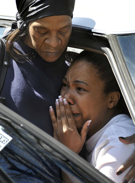 Second Place, Photographer of the Year Small Market - Marshall Gorby / Springfield News-SunLinda Portis of Springfield comforts her niece, Candace Johnson, of 726 S. Lowry St., after Johnson's house caught fire Wednesday, April 8. Johnson smelled smoke and had gotten her three children, ages 8, 5, and 3, onto the front porch when she heard an explosion behind her. "My whole life was in there," she said. No one was hurt in the fire, which the fire department believes started in the house's pantry. The fire department is investigating the source of the fire. 