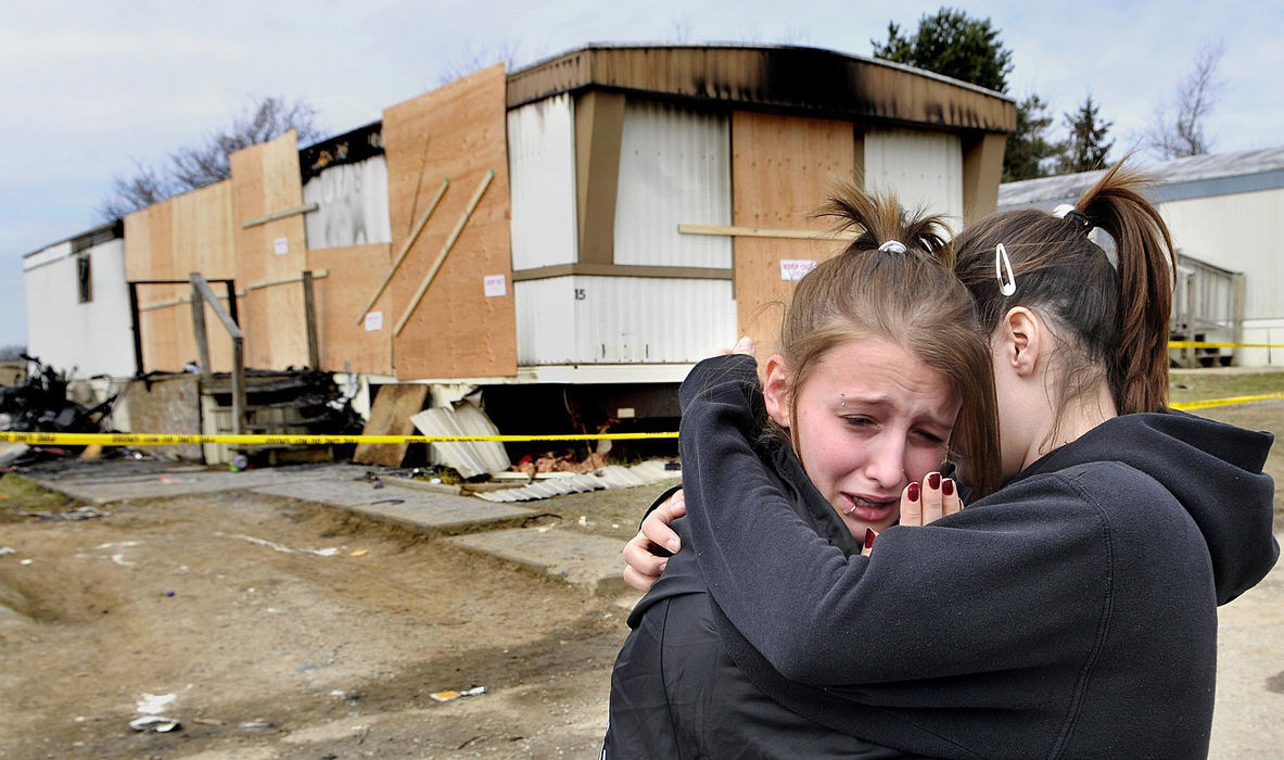 Second Place, Photographer of the Year Small Market - Marshall Gorby / Springfield News-SunHeather Swank, 15 (left) is comforted by her friend, Katie Rogers, 14, at the scene of a mobile home fire that claimed the lives of four children, March 21, 2009, near St. Paris. 