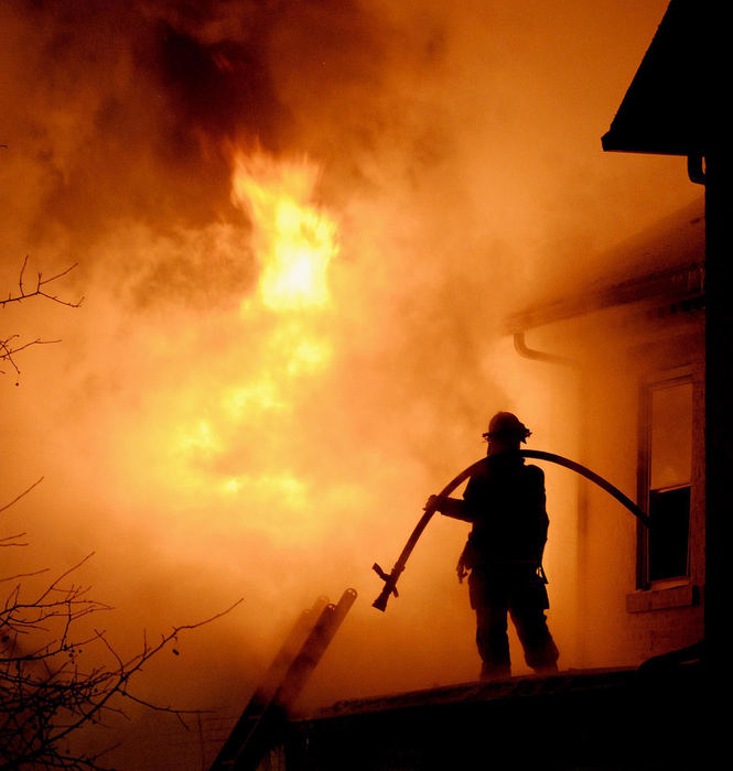 Second Place, Photographer of the Year Small Market - Marshall Gorby / Springfield News-SunA Bethel Township firefighter waits for water to battle a structure fire near New Carlisle around 1 a.m., January 16, 2009 on New Carlisle Pike.