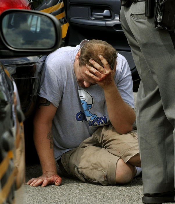 Second Place, Photographer of the Year Small Market - Marshall Gorby / Springfield News-SunJames Newton holds his head while leaning against a Clark County Sheriff's cruiser after the pickup truck he was driving struck and killed a friend and co-worker, Sept. 7. Newton attempted to give the victim, Kevin McArthur, CPR after the incident but with no success.