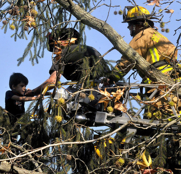 Second Place, Photographer of the Year Small Market - Marshall Gorby / Springfield News-SunDanny Richardson, 6, reaches out to Enon firefighter, Bob Wagner as Bethel Township firefighter Jason Chesser assists in the rescue of the little boy who had climbed a 25-to-30 foot tree in his Grandmother's front yard at 368 Lammes Lane on Nov. 7.  