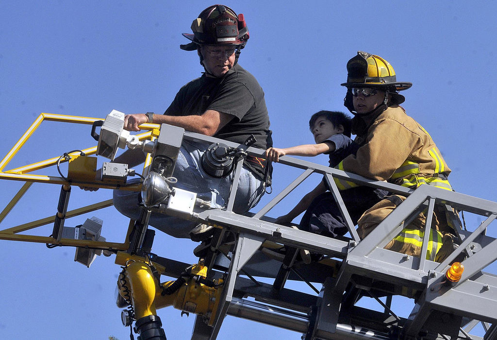 Second Place, Photographer of the Year Small Market - Marshall Gorby / Springfield News-SunEnon firefighter, Bob Wagner and Bethel Township firefighter Jason Chesser assists in the rescue of the little boy who had climbed a 30 foot tree in his Grandmother's front yard at 368 Lammes Lane on Saturday, Nov. 7. 