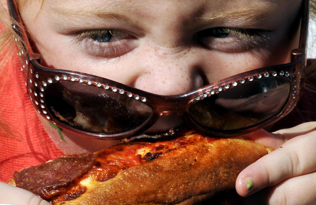 First Place, Photographer of the Year Small Market - Bill Lackey / Springfield News-SunAustyn Bunn, 6, didn't stop eating pizza, even when her sunglasses fell down during the annual pizza eating contest at the Champaign County Fair, August 12, 2009. 