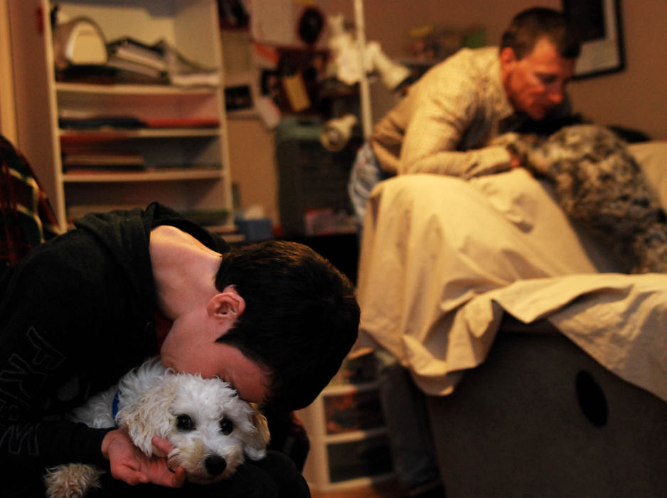 Third Place, Photographer of the Year Small Market - Tessa Bargainnier / Kent State UniversityJen and Tom spend quality time with their two dogs Andrew and Suzy before heading to bed in their trailer in Missouri.