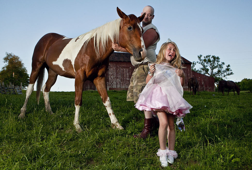 Third Place, Portrait Personality - Diego James Robles / Ohio UniversityLittle Miss Chauncey Dover, Heidi Jo McGrady, 7, of Logan,  screams and cries during a portrait session after her favorite horse, Freckles, crewed on her brand-new pink dress, on May 31, 2009. Heidi immediately yelled at her father, “Freckles ate my dress!” 
