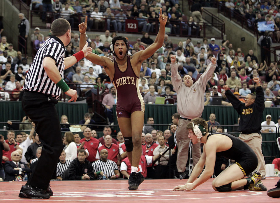 Second Place, Sports Action - Adam Cairns / ThisWeek NewspapersWesterville North coach David Grant and father Lou Demas leap out of their seats as Josh Demas defeats Lakewood St. Edward's Nick Sulzer in the 152-pound class during the Division I finals of the state wrestling tournament at Ohio State's Schottenstein Center on March 7. 