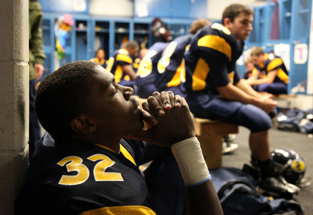 Third Place, Sports Feature - Tracy Boulian / The Plain DealerSolon's Christian Jackson takes a moment for himself in the locker room before the game between Solon and Brunswick at Solon, October 9, 2009. 