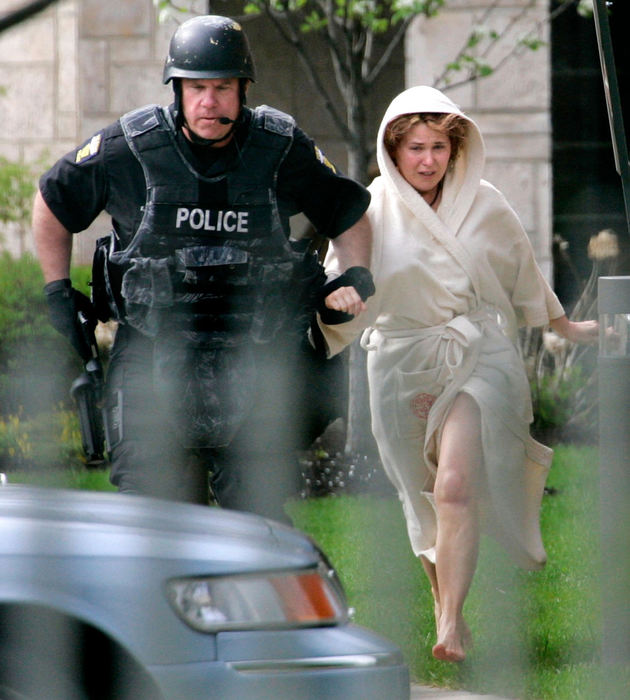 Second Place, Spot News (over 100,000) - Dave Zapotosky / The BladeCaption: Barbara Swiergosz (right) runs with a Toledo police officer after being released by her estranged husband Michael Swiergosz in Toledo, April 28, 2009. Swiergosz released her after holding her at gunpoint for more than five hours at a Toledo retirement community. 