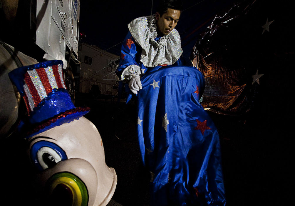 First Place, Student Photographer of the Year - Diego James Robles / Ohio UniversityA hired hand, whose primary duty is assembling and disassembling the circus tent, struggles to put on a baggy clown costume moments before the final parade of the night’s show, on Tuesday, March 24. In the chaotic circus life, most participants have multiple jobs and responsibilities; often working from dawn to dusk. 