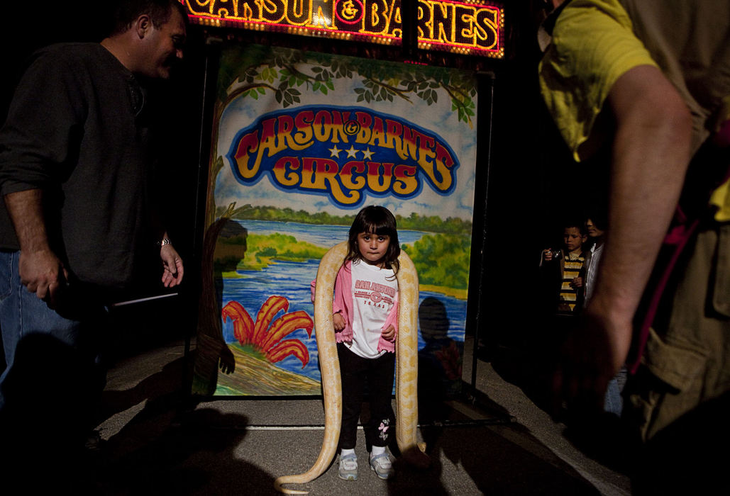 First Place, Student Photographer of the Year - Diego James Robles / Ohio UniversityDuring a show intermission on Sunday night, March 29, Jessica Roberts, 4, doesn’t know where to look as she reluctantly poses with a large white and yellow python while her father figures out his camera settings.