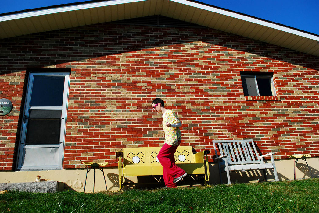 Second Place, Student Photographer of the Year - Tessa Bargainnier / Kent State UniversityJen walks around the farmhouse in search of barn cats to play with while she waits for Tom to pull the tractor out. 