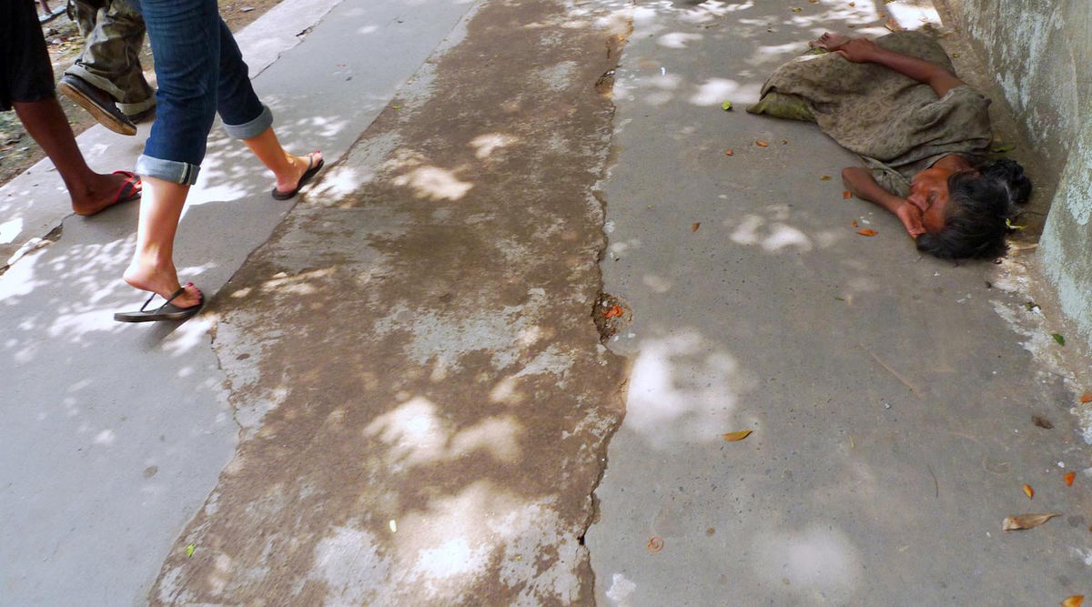 Third Place, Student Photographer of the Year - Laura Torchia / Kent State UniversityLeah Sherry, a high school teacher from Toronto, Canada, walks the streets of Kolkata as a woman takes a mid-afternoon rest on the sidewalk.