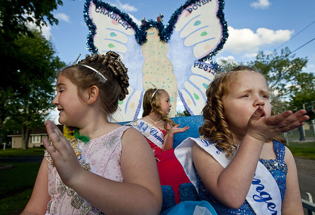 First Place, Student Photographer of the Year - Diego James Robles / Ohio UniversityAtop their float and in the final leg of the parade route during McArthur’s Turkey Festival, from left, Hannah, Heidi Jo and Tomi Sue wave and smile to the empty streets on the way home.