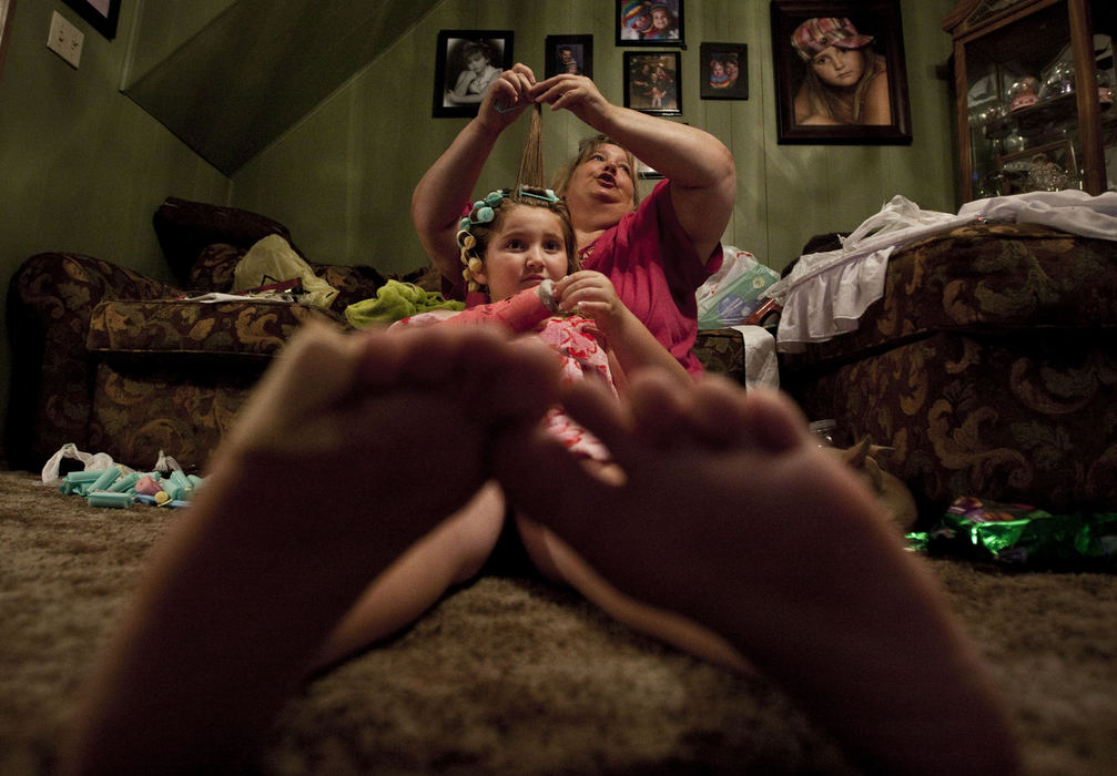 First Place, Student Photographer of the Year - Diego James Robles / Ohio UniversityHannah watches the Jonas Brothers on T.V. at home in Lexington while her grandmother, Cathy, applies rollers to her hair the night before the beauty pageant. Hannah won first attendant last year and is considered the favorite by many for this year's crown.