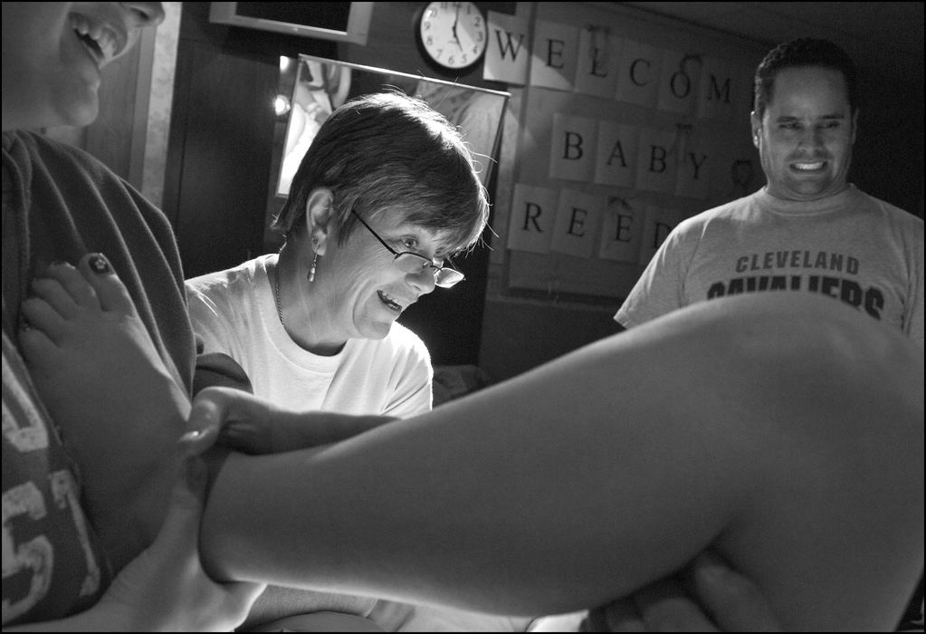 Third Place, Student Photographer of the Year - Laura Torchia / Kent State UniversityLabor and delivery nurses and Midwife Sue Hudson share a laugh with Sylvia between pushes as husband Ivan Reed looks on.