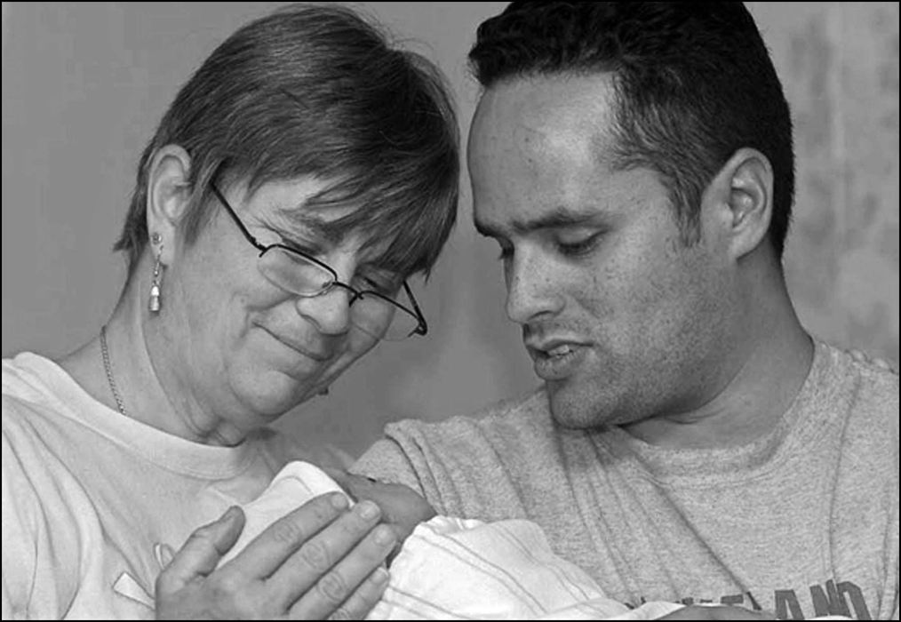 Third Place, Student Photographer of the Year - Laura Torchia / Kent State UniversityMidwife Sue Hudson takes a moment with new father Ivan Reed, to celebrate the last child born at WRH and the mom, one of their own nurses.