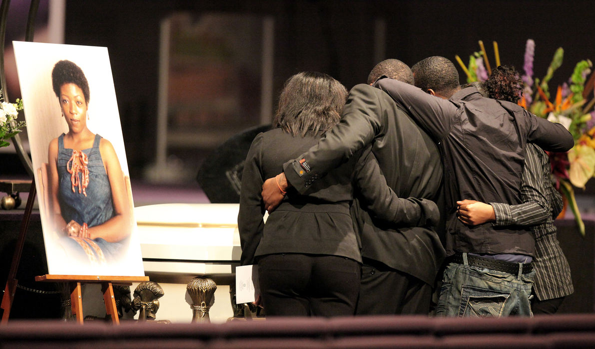 First Place, Team Picture Story - Lisa DeJong / The Plain DealerEleven separate funerals were held for the victims of Imperial Avenue.  Here, relatives of Amelda Hunter gather around her casket at The Word Church in Warrensville Heights.  Hunter was last seen alive in April. 