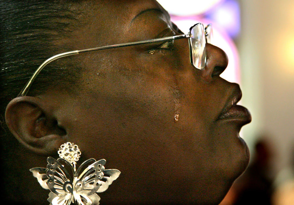 First Place, Team Picture Story - Thomas Ondrey / The Plain DealerAlice Matthews of Cleveland mourns with others at funeral services for Janice Webb held at St. Timothy Baptist Church on Nov. 16, 2009.  Matthews said she was a close friend of Webb, one of the 11 women found buried on the Imperial Avenue property of Anthony Sowell.  