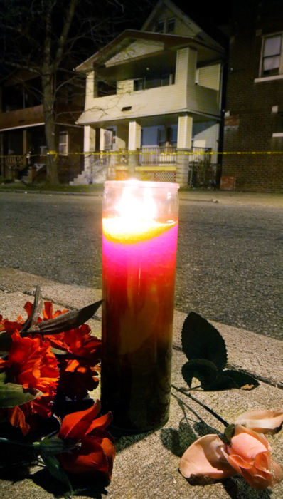 First Place, Team Picture Story - John Kuntz / The Plain DealerA prayer candle sits among flowers placed on the sidewalk on the corner of Imperial Avenue and East 123rd Street across the street from the home of alleged mass murderer Anthony Sowell.