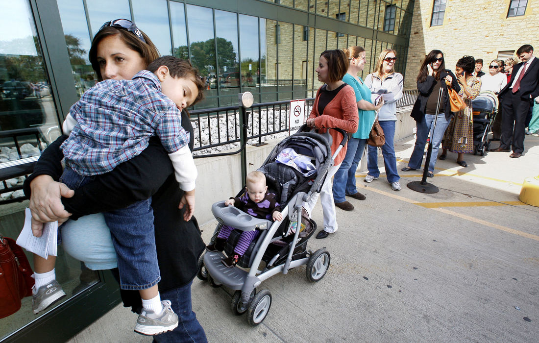 Second Place, Team Picture Story - Jeff Hinckley / The Columbus DispatchKasey Conyers, of Victorian Village, who is 9 months pregnant, holds her son Greyson, 3, in a line of healthcare workers, pregnant women and caregivers of young children waiting for their flu shots at the Columbus Public Health building on Parsons Ave., Oct., 20, 2009.