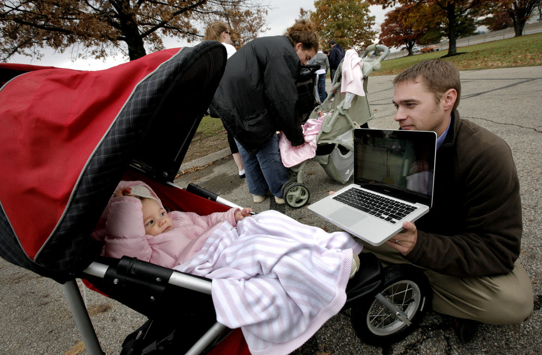 Second Place, Team Picture Story - Fred Squillante / The Columbus DispatchNathan Fischer brought a laptop and a movie (Monsters Inc.) to keep daughter Elle, 22 months, occupied as they wait in line for an H1N1 flu shot at the Ohio Historical Society, Oct. 28, 2009.