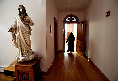 First Place, Feature Picture Story - Lisa DeJong / The Plain DealerMother Dolores enters The Choir, a chapel in her cloistered living quarters inside the Monastery of the Blessed Sacrament.  The monastery was built in 1905 and the gleaming, spotless woodwork shows little wear. 