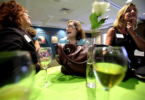 Second Place, Feature Picture Story - Lisa DeJong / The Plain DealerHer speech over and her nervousness gone, Connie Culp is back to her old self, joking with guests at a reception after the opening of LifeBanc's new offices. Connie is becoming more comfortable floating around in different social circles of people, far removed from her rural, southern Ohio home. 