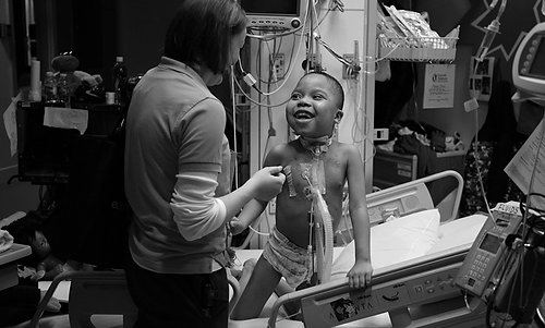 Third Place, Feature picture story - Michael E. Keating / MIchael E. KeatingManny Evans, 7, has lived five of his seven years as a resident of Cincinnati Children's Hospital Medical Center.  Diagnosed with neurofibromatosis the genetic disorder that forms tumors that surround nerves, Manny  requires medical and nursing care beyond what can be provided in a residential environment.  His mother chooses to let him live at the hospital instead of a residential center or nursing home.  Manny recently began his schooling at Roselawn Condon School and a school bus picks him up each day in front of the hospital.  A fleet of nurses, personal attendants and caregivers provide the love and care, emotionally and physically, often the responsibility of a parent.  