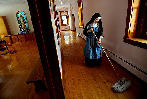 First Place, Feature Picture Story - Lisa DeJong / The Plain DealerSister Faustina, 23, the youngest nun in the cloister who is in her twenties,  sweeps the halls every day in her cloistered living quarters.With the exception of a couple of extern nuns who run errands, answer telephone and meet with the public, the sisters never leave the convent save for medical treatment. Other contact with the outside world comes by way of the daily newspaper which is read by extern sisters.