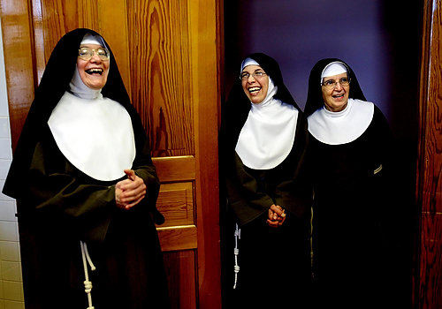 First Place, Feature Picture Story - Lisa DeJong / The Plain DealerThe sisters tease one another, tenderly, with the knowing familiarity of a closely knit family. "We're pretty free about laughing, even though we try to keep silence through the day, " Mother Dolores says. Some have lived with each other for 30 years. From left, Mother Dolores, Sister Chiara Francesca and Sister Therese laugh in the kitchen.