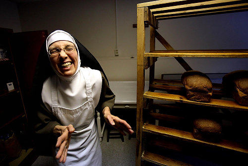 First Place, Feature Picture Story - Lisa DeJong / The Plain Dealer For the Poor Clares' "everyday" breakfasts and suppers, Sister Chiara Francesca turns out wheaten loaves called Graham bread, which is served with margarine.  In her former life, Sister Chiara was an obstetrics nurse. 