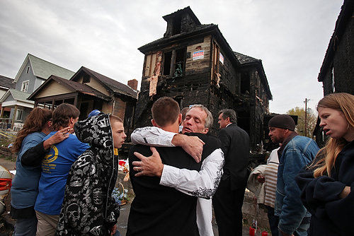 Award of Excellence, General News - Tom Dodge / The Columbus DispatchDarrell Parfitt hugs his nephew  Keith Climer  after a news conference where investigators announced a $5,000.00 reward in the arson deaths that killed three people including Darrell's mother Deanna Perry. 