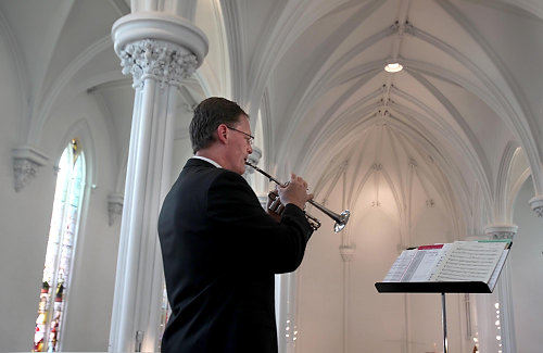 Second Place, News Picture Story - Gus Chan / The Plain DealerErik Sundet plays the trumplet during  the final mass at St. Peter Church on Easter Sunday.  St. Peter Church closed it's doors after 150 years as part of Bishop Richard Lennon's reorganization. 