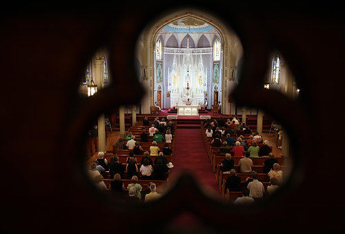 Second Place, News Picture Story - Gus Chan / The Plain DealerParishioner kneel to pray during the final service at St. Emeric Church.  Bishop Richard Lennon cancelled the final mass and the parishioners elected to hold a prayer service in it's place.