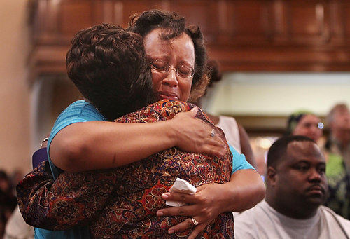 Second Place, News Picture Story - Gus Chan / The Plain DealerElayna Hodges fights back tears as she hugs Leola Wilson during the final mass at St. Adalbert Church.