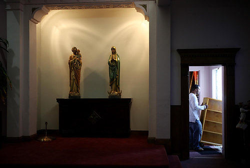 Second Place, News Picture Story - Gus Chan / The Plain DealerSpencer Belcher moves a bookcase out of St. Cecelia Catholic Church.  St. Cecelia will close it's doors for the final time after Sunday morning's mass.