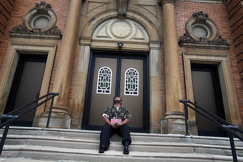 Second Place, News Picture Story - Gus Chan / The Plain DealerGeorge Gamble, a lifelong St. Adalbert parishioner,  fights back tears as he sits outside the closed church.  St. Adalbert, home to Cleveland's oldest black Catholic congregation, closed it's doors for the final time morning as part of the diocesan downsizing. 