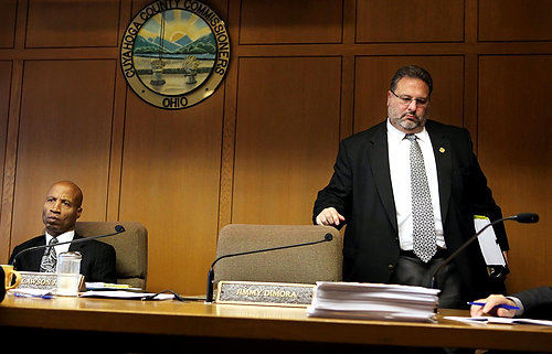 First Place, James R. Gordon Ohio Understanding Award - Gus Chan Gus Chan / The Plain DealerCuyahoga County Commissioner Jimmy Dimora, a central figure in a massive public corruption investigation, avoids the spotlight  by leaving before the close of his final board meeting.  In January, an elected executive and an 11-member council are to assume control of the county, ending more than 200 years of rule by commissioners.   Dimora is expected to go on trial in the summer of 2011.